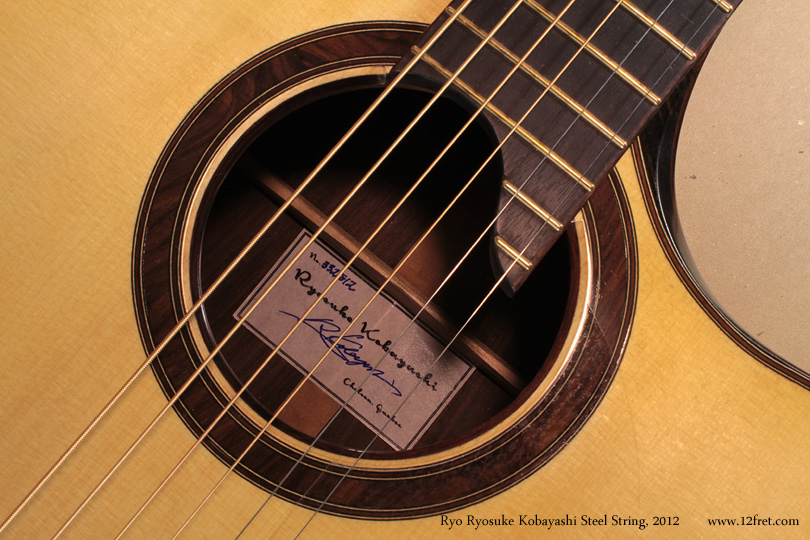 Here is a wonderful flat-top steel string guitar from Ryo Ryosuke Kobayashi, built during 2012.    Ryo Ryosuke Kobayashi apprenticed to Sergei de Jonge at his shop in Chelsea, Quebec.  

This impressive instrument features a somewhat oversize classical shaped body and an elegant contoured cutaway.  The top is bound and the purfling follows the line of the cutaway very nicely.