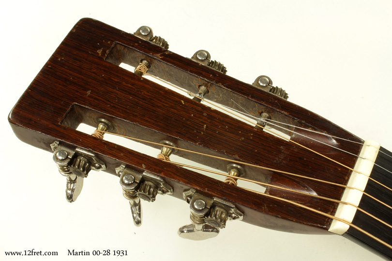 Here's a rare treat - a 1931 Martin 0028.   Adding to the value and historical interest of this instrument is a set of photos of the original owner playing it while in the Canadian Forces in the European Theater during World War 2!