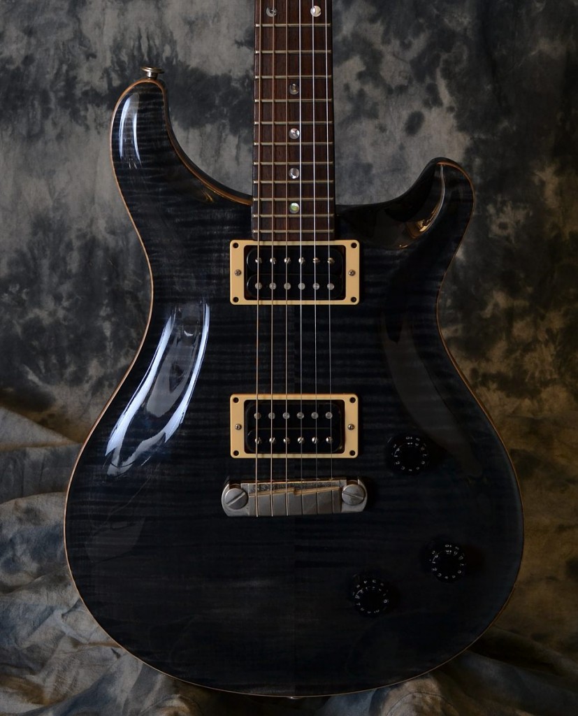 This slate black Custom 22 has a very nice looking 10 top flame maple cap to top off the elegant body shape, versatile tones and excellent playability on this very cool guitar. It is in excellent shape with very little play wear and comes with the original PRS hardshell case!!