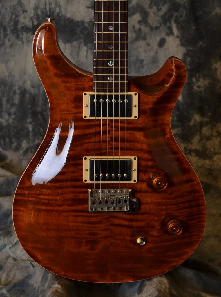 Well this is one heck of a buy for a great guitar!! This beautiful amber finish PRS is in excellent shape, plays really well and comes with the original hardshell case and all the case candy!