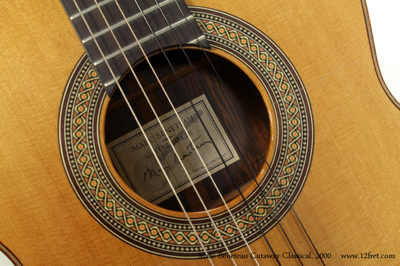 This is a beautiful and well-preserved piece - a 2000 Marc Beneteau cutaway classical crossover, featuring very nicely figured cocobolo sides and back and a cedar top.   It has almost no wear; the finish has sunk into the wood, which is a natural part of aging, and that's pretty much the only sign that this isn't a new instrument.