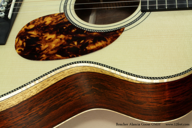 Boucher guitars are fairly new for us, but they bring a fully developed and realized instrument line.    
Today we have a Boucher Guitars Alancia Goose OMH, or Orchestra Model Hybrid.   This model features cocobolo back and sides, this specific example a wood set with lovely sapwood providing visual effects.