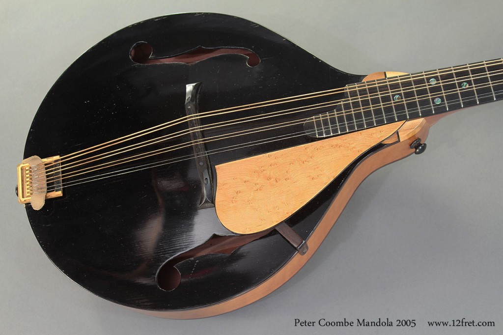 This fine 1999 Peter Coombe Mandola is built with European spruce for the top, Tasmanian Myrtle for the sides, back, and neck, and ebony for the fingerboard and headplate. The pickguard is birds-eye maple, and it's finished with a traditional varnish.