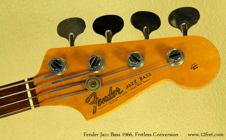 Here's a lovely Fender Jazz Bass from 1966, converted to fretless in 1985 by Joe Kovacic at Lado Guitars. This instrument has definitely been used as was intended, with the honest wear that implies.As people discovered the potential of the fretless sound - Pastorius in Weather Report probably had a lot to do with that - fretless conversions became popular for a few extra reasons. The conversion is fairly quick to do, not exceptionally expensive, and is usually reversible. The frets are removed, veneer is glued into the slots, the board is planed level and the action set low. The Twelfth Fret's repair shop has done many of these conversions, in both directions.