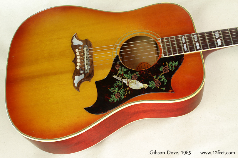 This is a 1965 Gibson Dove, with an original tune-o-matic bridge used as part of the standard pin bridge.