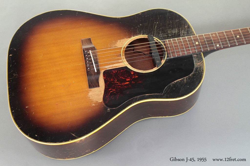 This 1955 Gibson J-45 has clearly been played, and has had some work done over the years; the original strip-mount Kluson Deluxe tuners have been replaced with Grover Roto-Matic models and a Fishman pickup with endpin jack has  been added, and at some point the bridge was replaced with a fixed-saddle design.