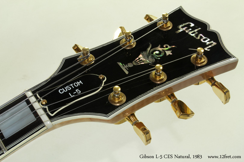 This 1983 example of the Gibson L-5 CES is in very good condition with a natural finish.   There's very little wear and the gold plating is in quite good shape; it's possible that the original owner rested a fingertip on the pickguard and the corner of the bridge pickup, and there's a little corrosion in the plating there.