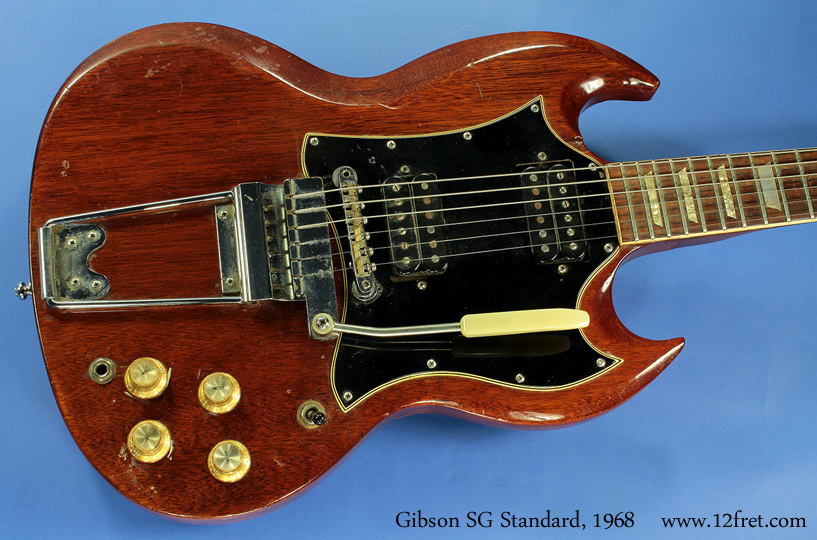 Gibson introduced what became the SG during 1961 as a Les Paul model.   With the end of the Les Paul endorsement deal for this guitar, the guitars were renamed to SG, though this process didn't end till 1963 when Gibson finally ran out of the 'Les Paul' branded parts!   The first production models carried 'PAF' pickups and a unique (and quickly discontinued!) side-pull trem. Various configurations of pickups, pickguards, bridges and tailpieces followed. 

 The 1968 SG Standard featured a larger 'batwing' pickguard, two humbuckers, Kluson tuners and the Maestro Vibrola.   
 
 This example is in good playing condition but was repaired long ago.