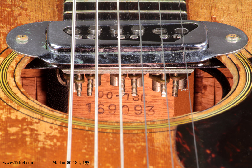 This is a pretty rare, 1959 Martin 00-18E steel string acoustic. 

The 00-18E was built from 1959 to 1964, in response to the quest for volume, and this is one of the first.   It uses the 00 style body, with the 18 construction - spruce top, mahogany back and sides - but the top is thicker and uses heavier bracing.