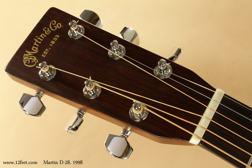 This is a very clean 1998 Martin D-28 Dreadnought guitar.   Martin introduced the Dreadnought body shape in 1916, building the first ones for the Oliver Ditson company - these did not carry the Martin brand name.  These instruments had mahogany backs and sides, and the necks joined the body at the twelfth fret.   The Ditson company disappeared in 1920, and the Dreadnought guitar went with it.
