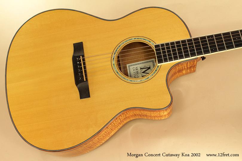 This is a lovely 2002 Morgan Concert Cutaway Koa Steel String Guitar, in excellent condition.   It's a full size guitar with a rounded Venetian cutaway, distinguishing it as an older model; most cutaway Morgans are now Florentine (pointed).  The highly figured Koa back and sides are very attractive, but also add a warm brilliance to the tone.